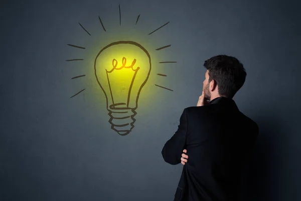 Businessman with lightbulb — Stock Photo, Image