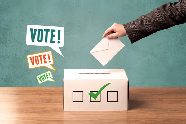 Placing a voting slip into a ballot box — Stock Photo, Image