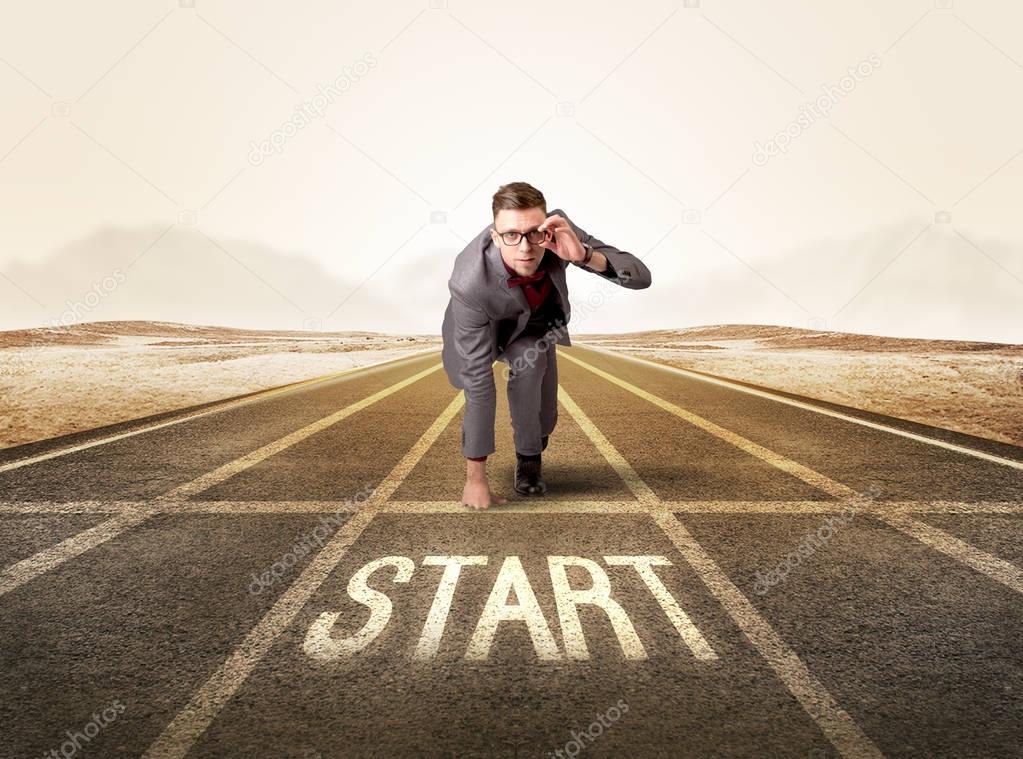 Businessman kneeling in ready position