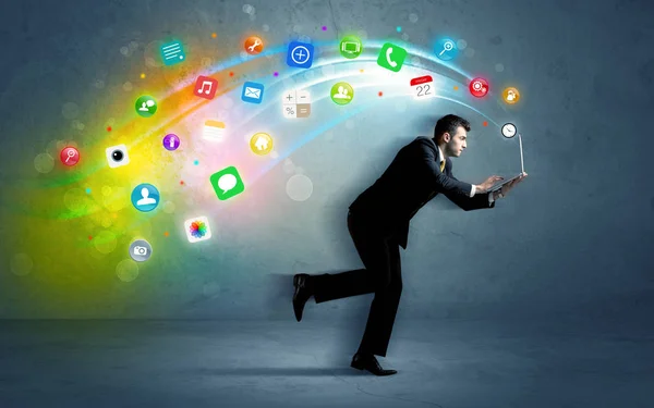 Running businessman with application icons from device — Stock Photo, Image