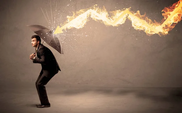 Business man defending himself from a fire arrow with an umbrell — Stock Photo, Image