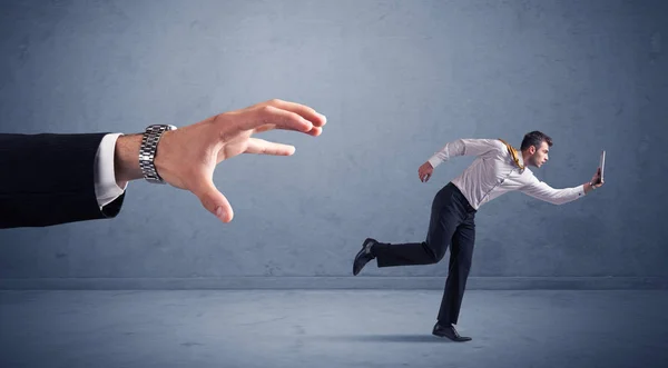 Businessman running from hand — Stock Photo, Image