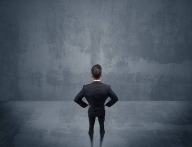 Şehir duvarının önünde duran iş adamı