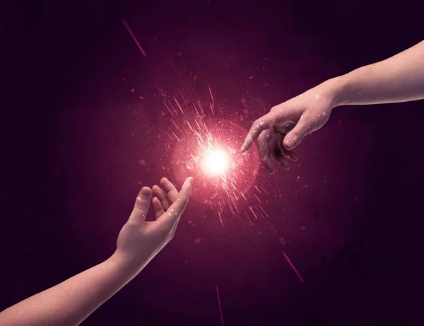 Touching hands light up sparkle in space