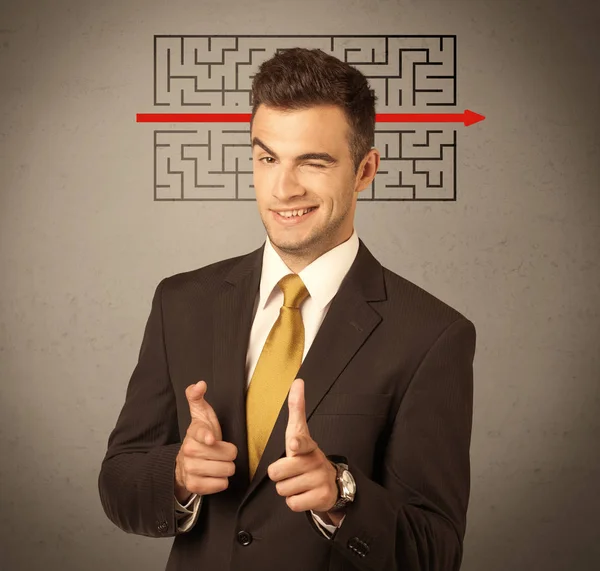 Handsome business guy solving maze — Stock Photo, Image