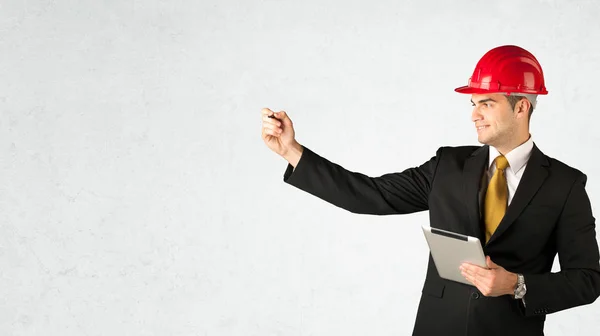 Young architect drawing in empty space — Stock Photo, Image