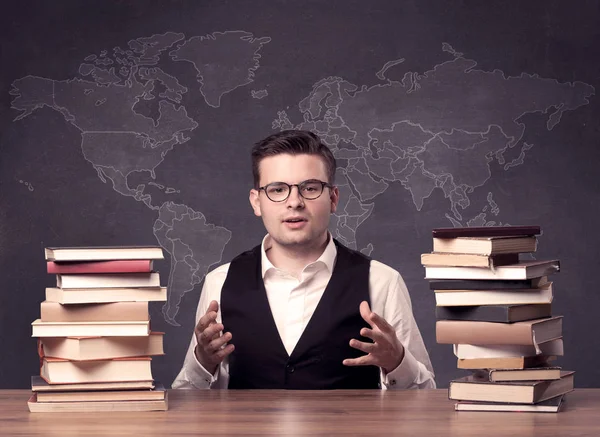 Geography teacher at desk — Stock Photo, Image