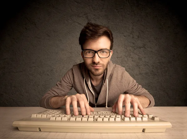 Computer geek typing on keyboard — Stock Photo, Image