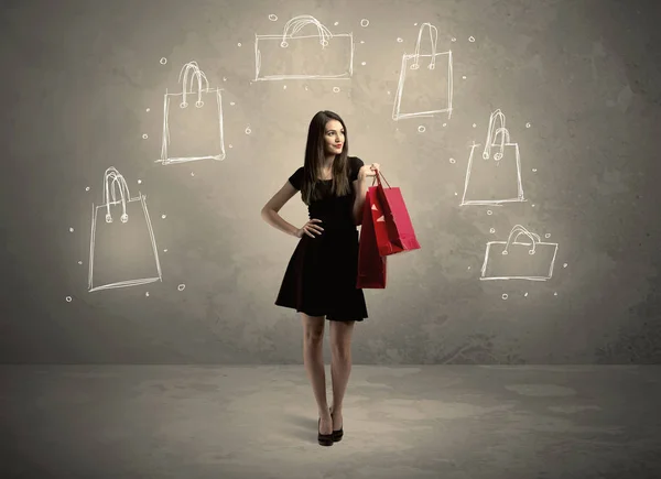 Señora del centro comercial con bolsas de compras dibujadas en la pared —  Fotos de Stock