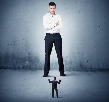 Öfkeli büyük iş adamı küçük adama lokma atıyor.