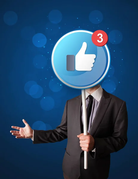 Affärsman med facebook skylt — Stockfoto