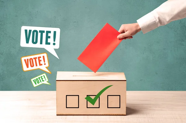 Placing a voting slip into a ballot box — Stock Photo, Image