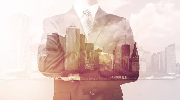 Businessman standing at cityscape background — Stock Photo, Image