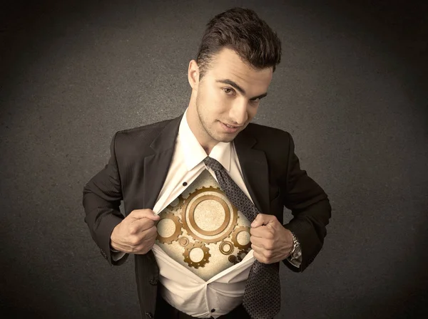 Businessman tearing shirt off and machine cog wheel shows — Stock Photo, Image