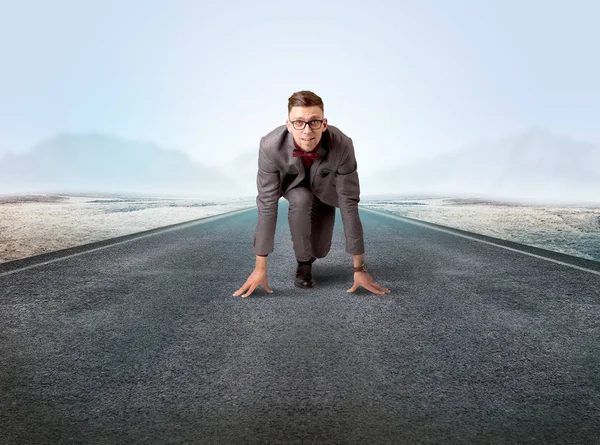 Businessman kneeling in ready position Stock Image