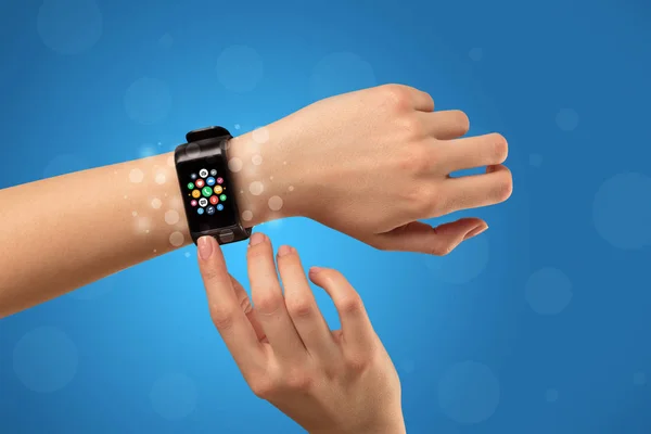 Female hand with smartwatch and app icons — Stock Photo, Image