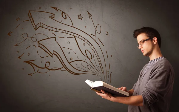 Young man holding book with arrows — Stock Photo, Image