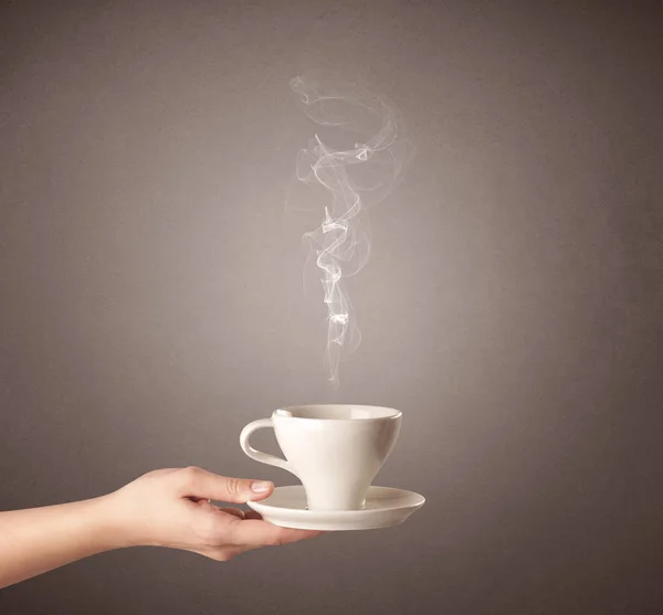 Vrouwelijke hand bedrijf koffie beker — Stockfoto