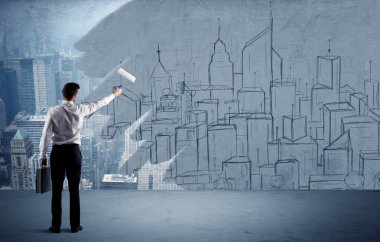 Zarif satıcı şehri duvarda yeniden boyuyor.