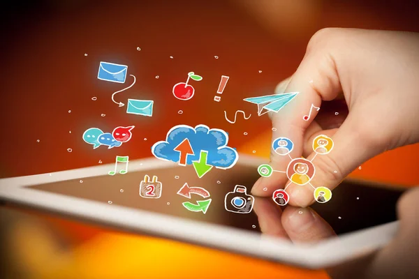 Fingers touching tablet with social icons — Stock Photo, Image