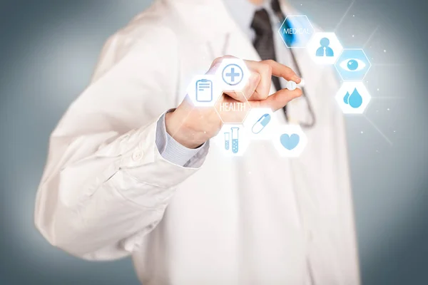 A doctor in white holding a pill — Stock Photo, Image