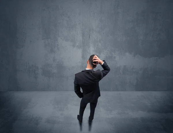 Homme d'affaires debout devant un mur urbain — Photo