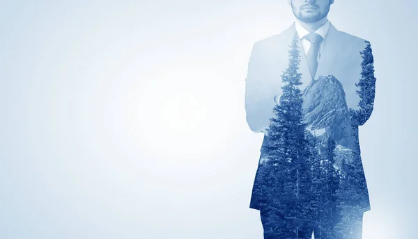 Businessman standing with mountain — Stock Photo, Image