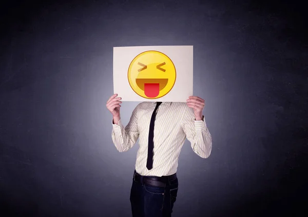 Empresário segurando papel com emoticon — Fotografia de Stock