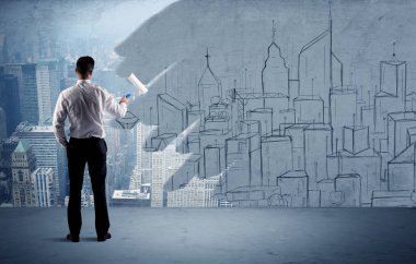 Zarif satıcı şehri duvarda yeniden boyuyor.