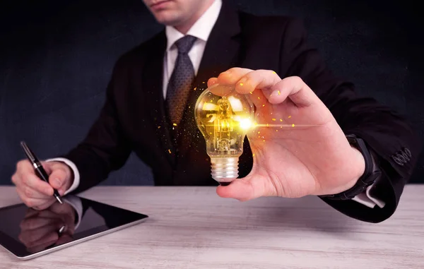 Office worker holding a light bulb — Stock Photo, Image