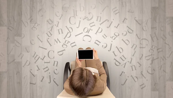 Letters with woman using laptop in a chair — Stock Photo, Image