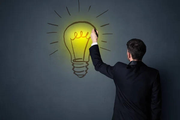 Businessman with lightbulb — Stock Photo, Image