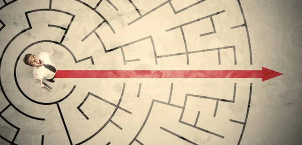 Business person standing in the middle of a circular maze — Stock Photo, Image