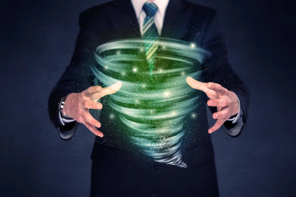 Businessman holding green tornado — Stock Photo, Image