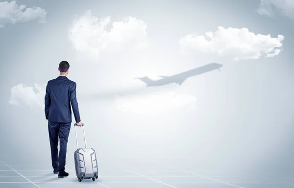 Businessman with luggage  look to an airplane — Stock Photo, Image