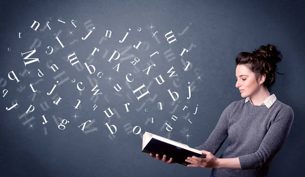 Young lady holding book with letters — Stock Photo, Image