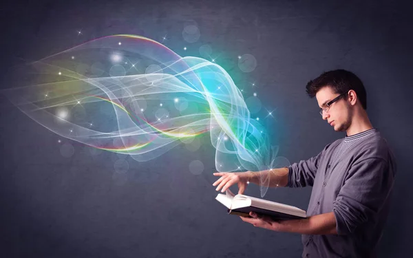 Young man holding book with waves — Stock Photo, Image