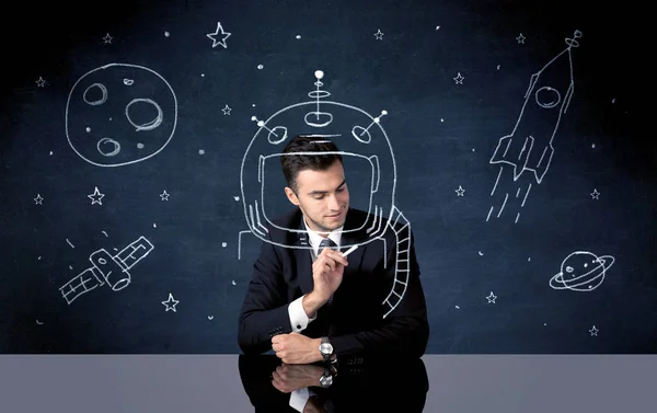 Sales person drawing helmet and space rocket