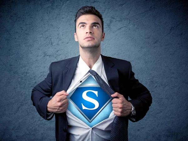 Businessman ripping off his shirt with superhero sign — Stock Photo, Image