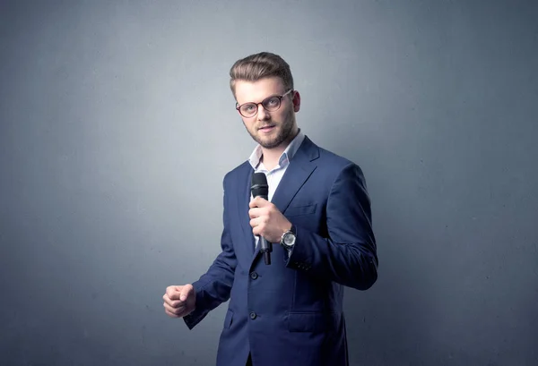 Businessman holding microphone — Stock Photo, Image