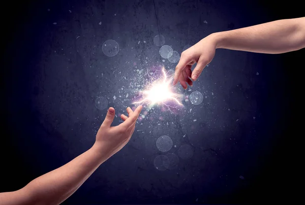 Hands reaching to light a spark — Stock Photo, Image