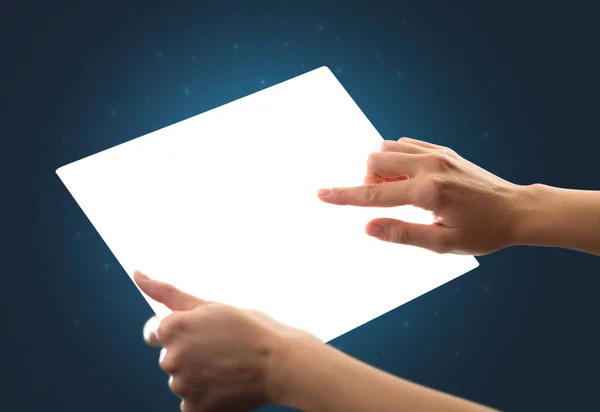 Hands touching a glass-like tablet — Stock Photo, Image