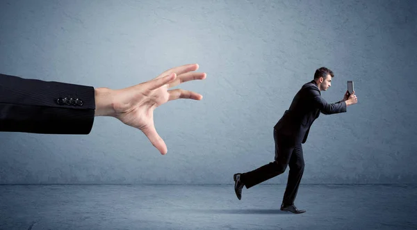 Businessman running from hand — Stock Photo, Image