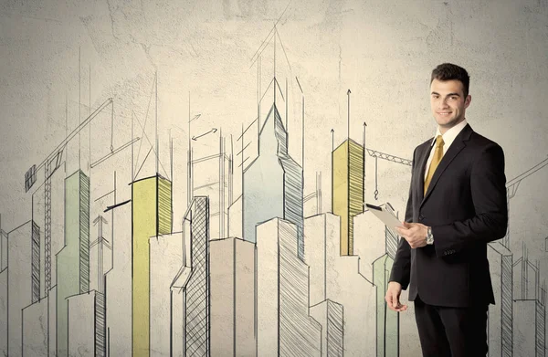 Biznesmen stojący z narysowanym krajobrazem miasta — Zdjęcie stockowe