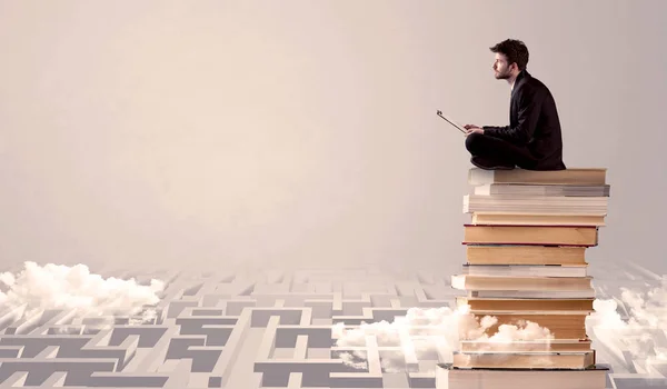 Uomo con tablet seduto sui libri — Foto Stock