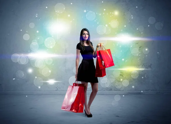 Mall κυρία με τσάντες ψώνια και glitter φως — Φωτογραφία Αρχείου