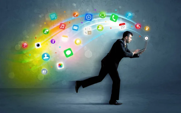 Running businessman with application icons from device — Stock Photo, Image