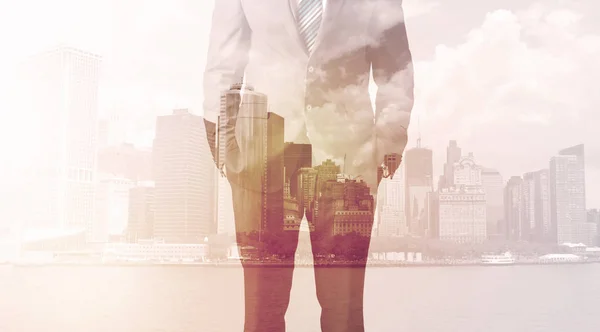 Businessman standing at cityscape background — Stock Photo, Image