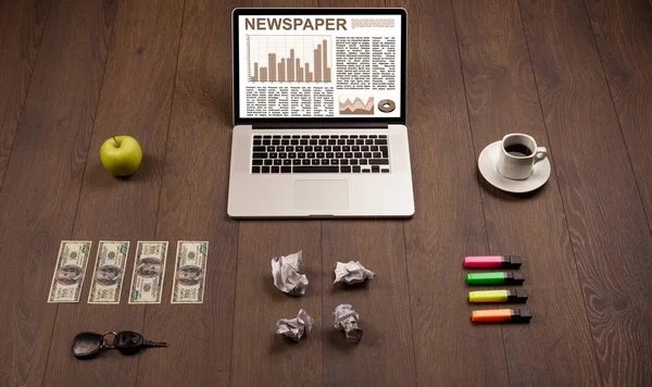 Business laptop with stock market report on wooden desk — Stock Photo, Image