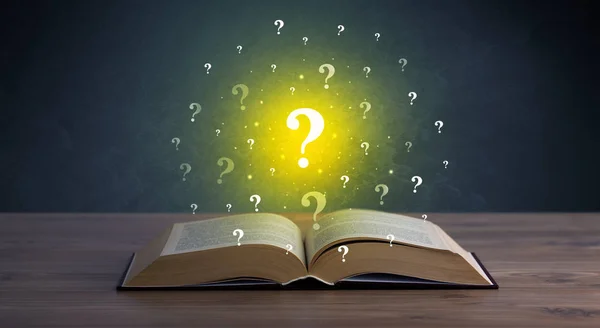 Question marks over book — Stock Photo, Image